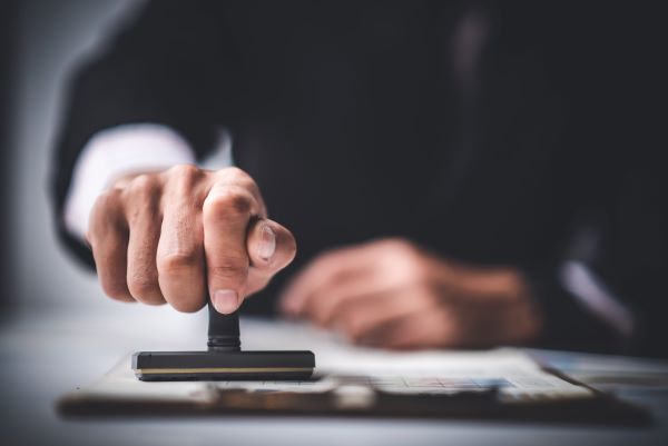 FINRA expungement concept photo, person's hand with a stamp